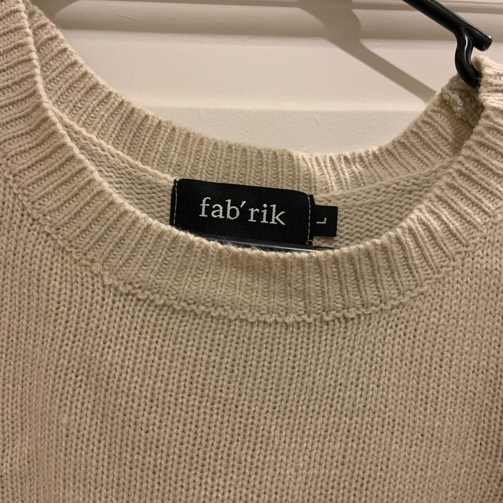 Tan fabrik sweater with peekaboo shoulders.